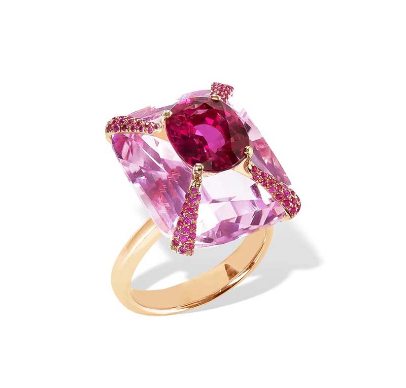 The somewhat lighter-colored stone below in the ring above, for example, is a 23.29-carat cushion-shaped violet-lithium faience. The larger oval stone on top is a 3.57 carat ruby.